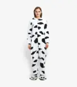 Full body view of a cozy cow kigurumi onesie for adults on a clean background.