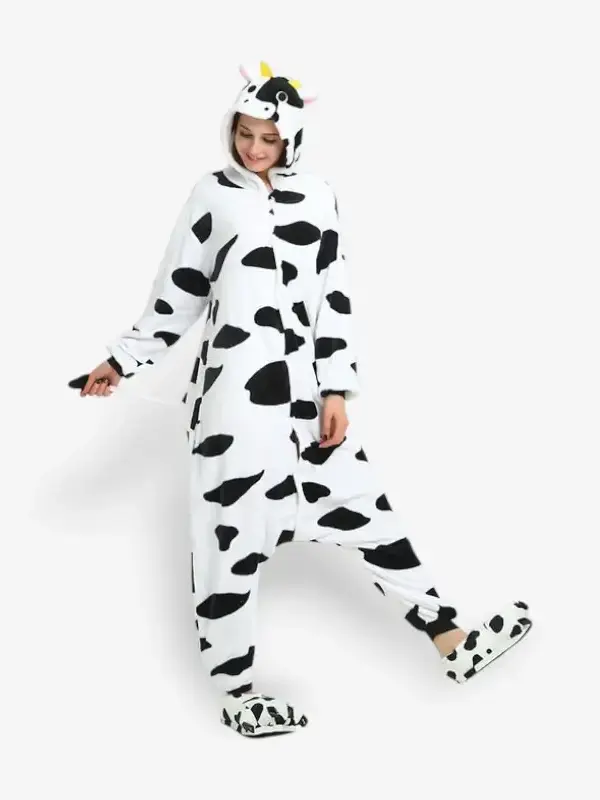 Woman modeling a comfortable adult cow onesie pajama costume.