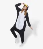Person enjoying a playful moment wearing a warm, black and white Penguin Onesie For Adults.