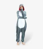 Woman smiling playfully with arms raised wearing the comfortable Shark Onesie For Adults.