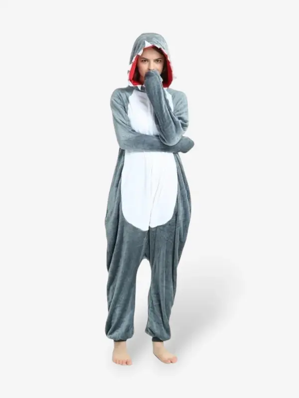 Woman smiling playfully with arms raised wearing the comfortable Shark Onesie For Adults.